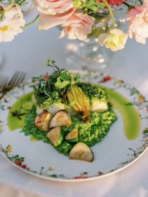 herb crusted halibut on a bed of ramp risotto with baby zucchini scaled