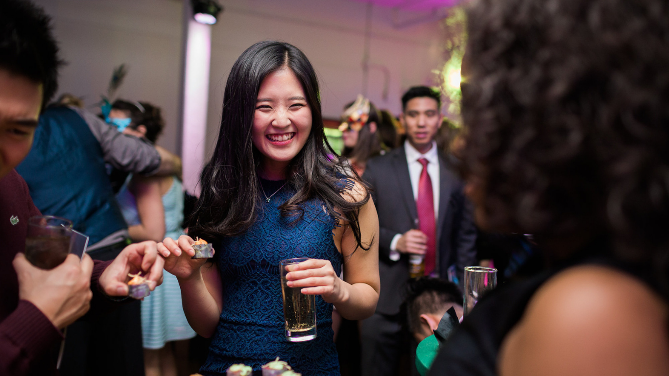 Guests sharing food and laughter at a Toronto corporate holiday party catered by elle cuisine.
